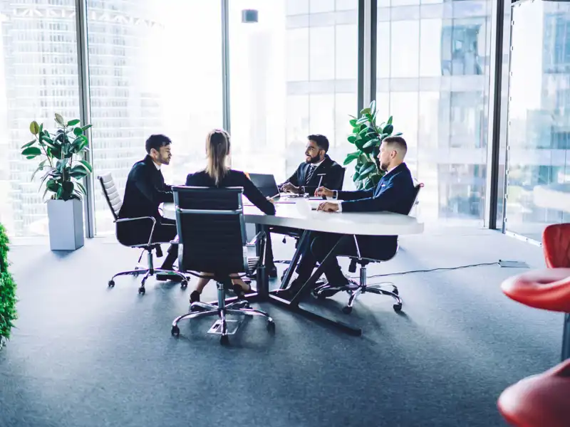 Team of partners have brainstorming meeting for consultancy about business plan.