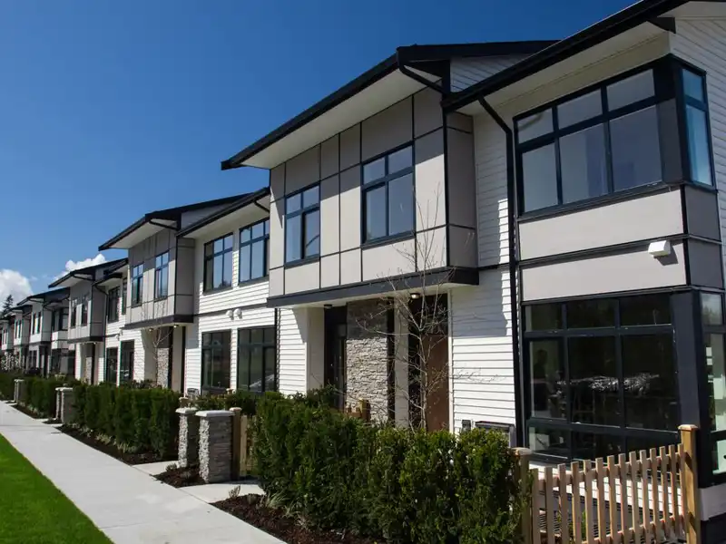 Residential townhouses on blue sky background on sunny day.