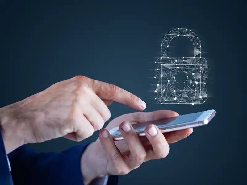 Cybersecurity lock over a phone screen.