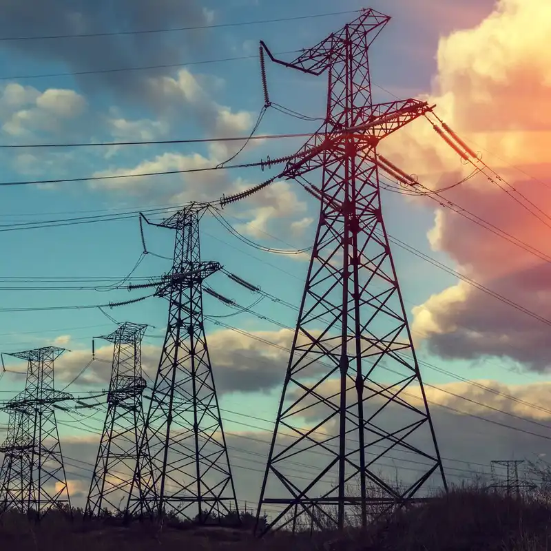 High-voltage power lines at sunset.