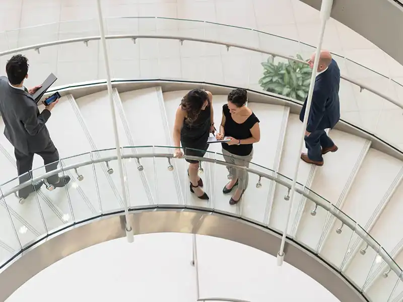 Professionals on a spiral staircase.