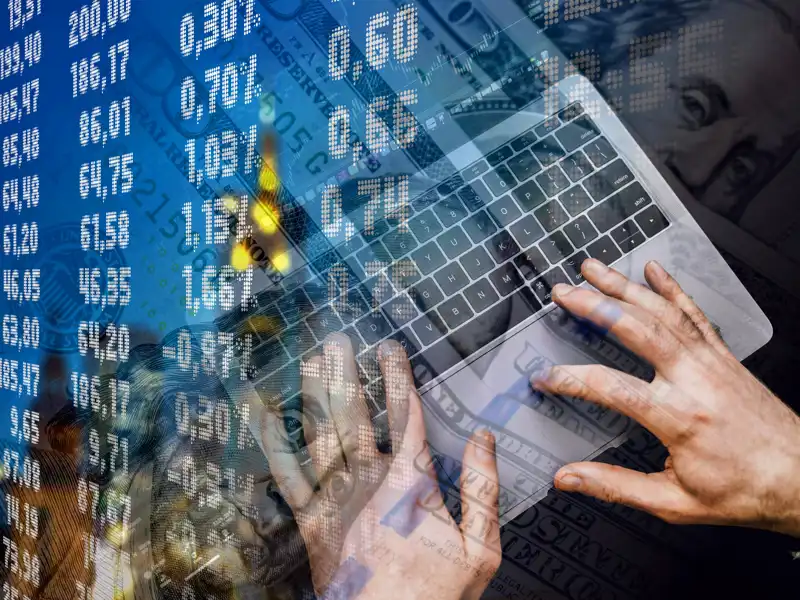 Digital stock screen on top of a laptop.