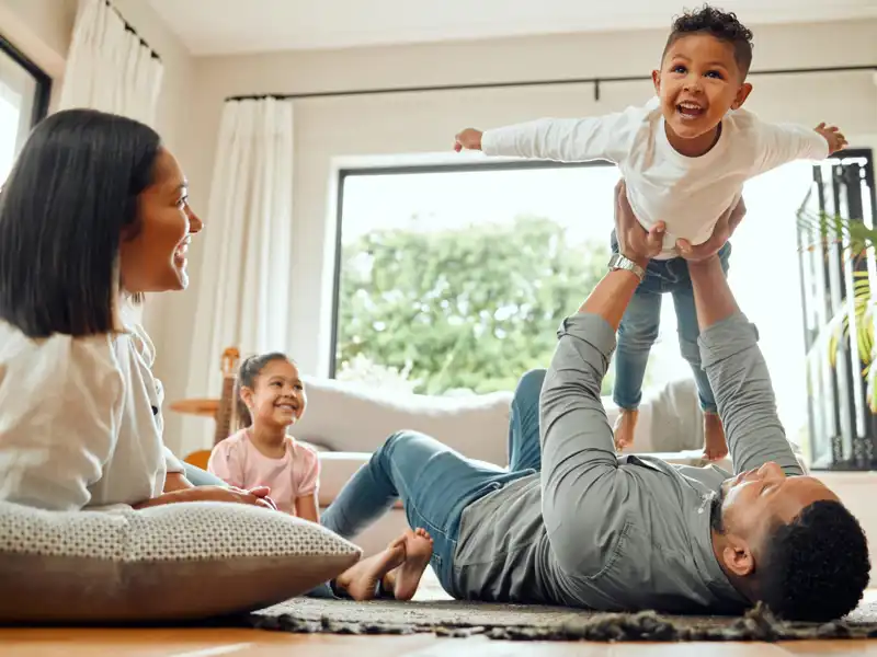 A family enjoys playing with their young child