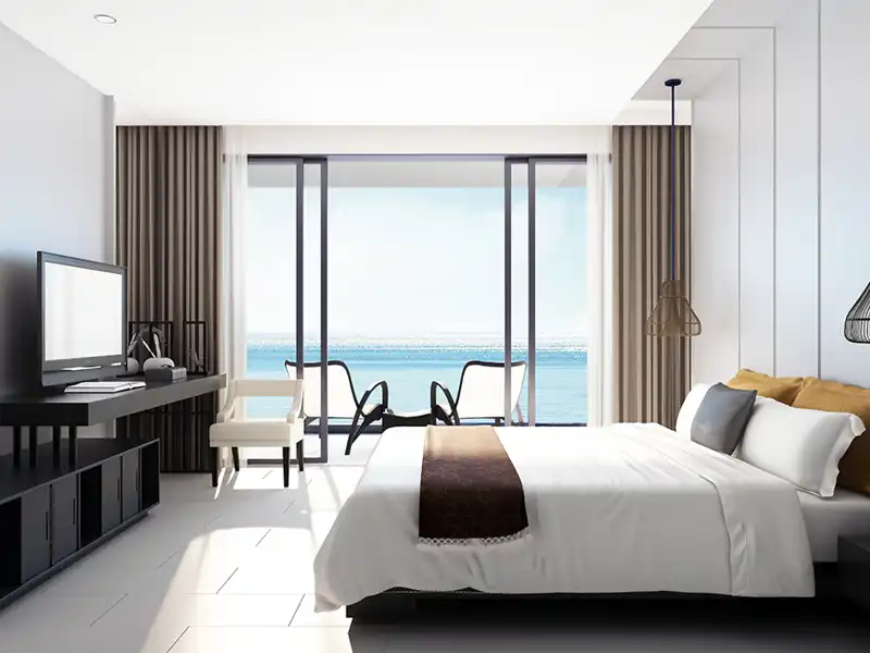A tidy hotel room overlooking the ocean