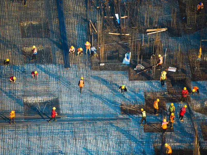 Construction workers position a vast sea of rebar.