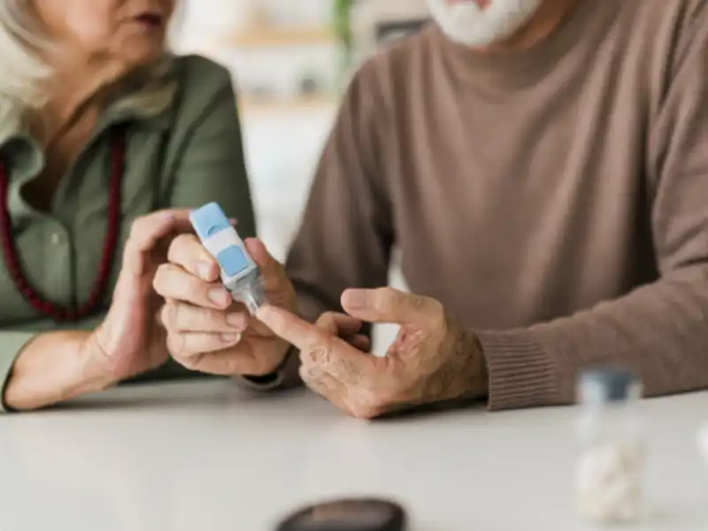 An older couple testing blood sugar, showcasing their concern and care for health and well-being.